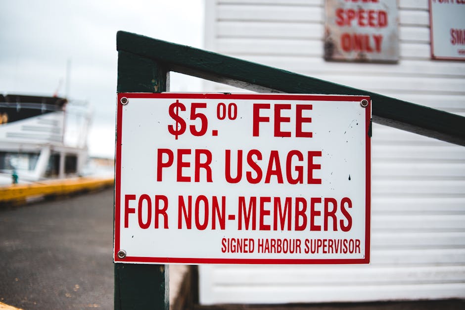 A close-up of a white rectangular sign with red bold text that reads, 