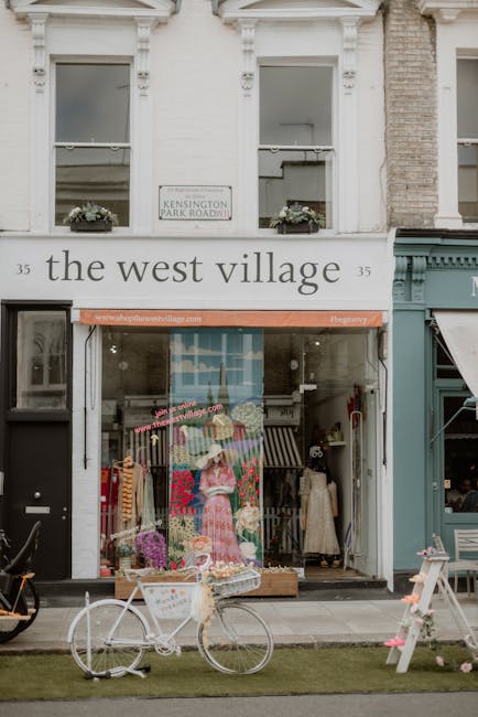 A floral display outside The West Village, a boutique flower and gift shop located near South Kensington station in SW7. The arrangement features a fresh bouquet of pink and purple flowers, including 